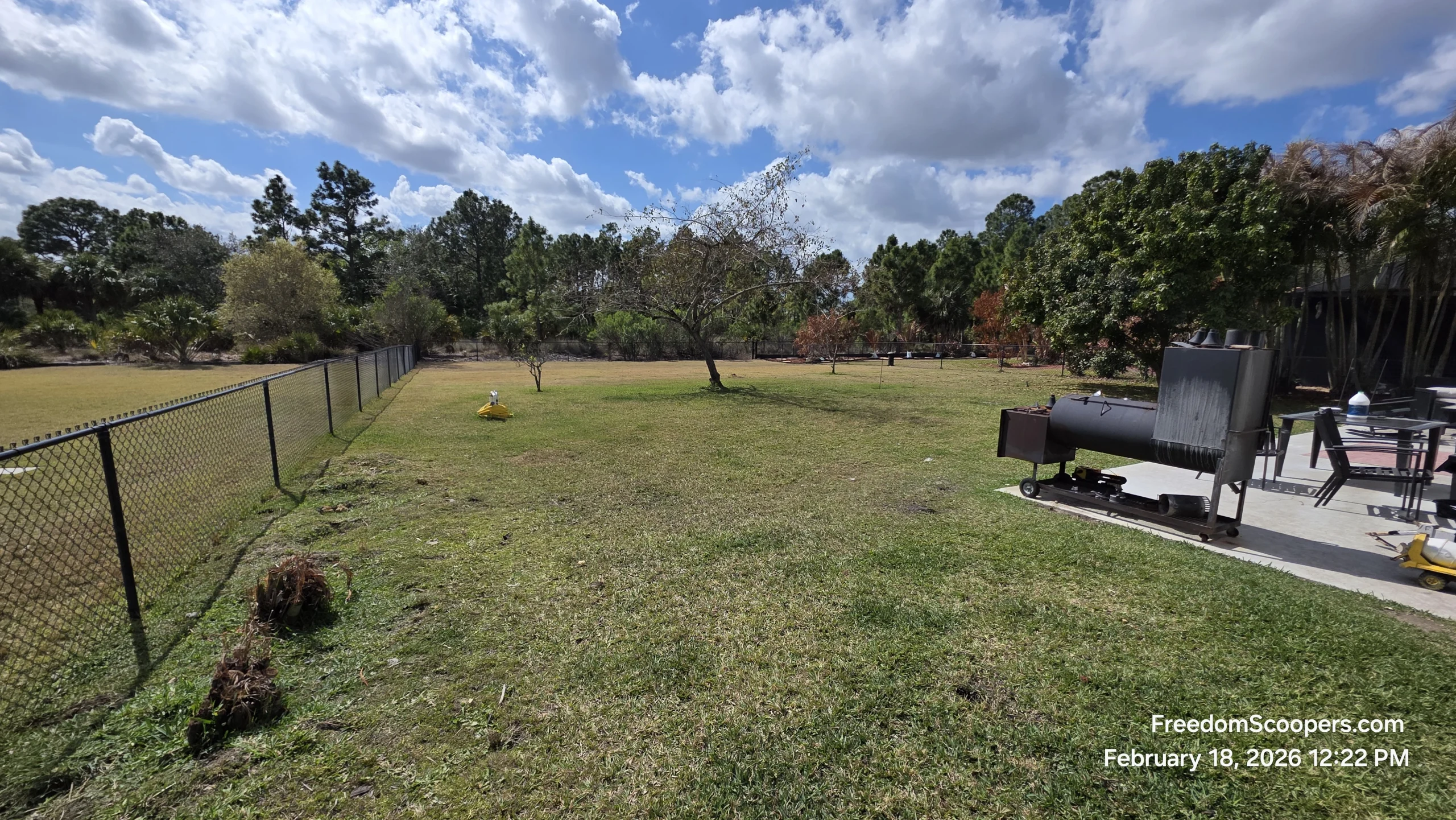 A clean fenced Lee County yard after dog waste removal